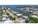 Aerial view of a charming home nestled along the water, surrounded by lush greenery and neighborhood at 501 Key Royale Dr, Holmes Beach, FL 34217