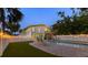 Backyard with a pool, lounge chairs, an outdoor dining area, and decorative string lights at 501 Key Royale Dr, Holmes Beach, FL 34217