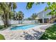 Backyard oasis features a pool, hot tub, patio area, and an outdoor living space at 501 Key Royale Dr, Holmes Beach, FL 34217