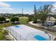 Outdoor basketball court surrounded by a green lawn and trees on a clear day at 501 Key Royale Dr, Holmes Beach, FL 34217