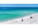 Beautiful beach scene with clear turquoise water, white sand, and people enjoying the sun and surf, creating a peaceful getaway at 501 Key Royale Dr, Holmes Beach, FL 34217