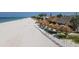 Picturesque beach featuring white sand, turquoise water, and tropical-themed beach bars with thatched umbrellas at 501 Key Royale Dr, Holmes Beach, FL 34217
