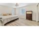Bedroom featuring hardwood floors, lots of light from windows, and a dresser at 501 Key Royale Dr, Holmes Beach, FL 34217