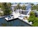 Beautifully landscaped waterfront home featuring a private dock and multi-level decking for outdoor living at 501 Key Royale Dr, Holmes Beach, FL 34217