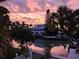 Stunning waterfront home featuring a two-story design, multiple balconies, lush tropical landscaping, and direct access to the water at 501 Key Royale Dr, Holmes Beach, FL 34217