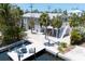 Charming two-story home with a dock and waterfront access, surrounded by lush landscaping and tropical foliage at 501 Key Royale Dr, Holmes Beach, FL 34217