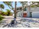Front exterior of a two-story home with a large tree, gray exterior, and red front door at 501 Key Royale Dr, Holmes Beach, FL 34217