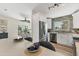 Bright, modern kitchen with white cabinets, stainless appliances, and bar seating overlooking dining area at 501 Key Royale Dr, Holmes Beach, FL 34217