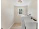 Bright laundry room with a washing machine, dryer, sink and window at 501 Key Royale Dr, Holmes Beach, FL 34217