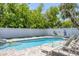 Backyard pool and patio with lounge chairs, and a fenced yard for privacy at 501 Key Royale Dr, Holmes Beach, FL 34217