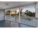 Inviting screened porch offering sunset views of lush tropical landscaping at 501 Key Royale Dr, Holmes Beach, FL 34217