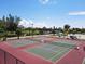 Well-maintained tennis courts with lush green landscape and open sky at 501 Key Royale Dr, Holmes Beach, FL 34217