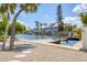 Stunning waterfront property featuring two homes along a canal, with private docks and palm trees under a bright sky at 501 Key Royale Dr, Holmes Beach, FL 34217