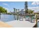 Scenic waterfront view featuring docks for boats and comfortable patio furniture, perfect for enjoying waterfront living at 501 Key Royale Dr, Holmes Beach, FL 34217