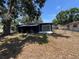 View of the home's backyard and screened-in patio area at 5030 Lahaina Dr, Sarasota, FL 34232