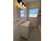 Bathroom with tile floors, wainscoting and vanity featuring framed mirror and modern lighting at 5030 Lahaina Dr, Sarasota, FL 34232