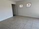 Cozy bedroom with tile flooring and two stained glass windows for natural light at 5030 Lahaina Dr, Sarasota, FL 34232