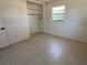 Bedroom featuring tile floor, closet and natural light at 5030 Lahaina Dr, Sarasota, FL 34232