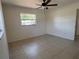 Bright bedroom with tile floor, ceiling fan and natural light at 5030 Lahaina Dr, Sarasota, FL 34232