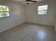 Bedroom with tile floor, ceiling fan and two windows at 5030 Lahaina Dr, Sarasota, FL 34232