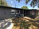 Rear of the home with a screened porch and a grassy yard at 5030 Lahaina Dr, Sarasota, FL 34232
