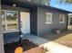 Inviting front entrance with a decorative white door, a large window, and a well-maintained landscaped area at 5030 Lahaina Dr, Sarasota, FL 34232