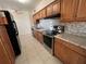 Modern kitchen featuring stainless steel appliances, granite countertops, and tile backsplash at 5030 Lahaina Dr, Sarasota, FL 34232