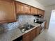 Modern kitchen featuring granite countertops, stainless steel appliances, and updated cabinetry at 5030 Lahaina Dr, Sarasota, FL 34232