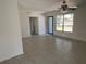 Open living room features tile floors, plenty of natural light, and access to other areas of the home at 5030 Lahaina Dr, Sarasota, FL 34232