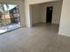 Open living area with sliding glass doors that lead to a screened lanai and the backyard at 5030 Lahaina Dr, Sarasota, FL 34232