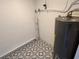 Water heater, situated near the textured decorative tile floor at 5030 Lahaina Dr, Sarasota, FL 34232