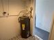 Water heater, view showing proximity to another room at 5030 Lahaina Dr, Sarasota, FL 34232