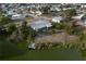 Aerial view showcasing waterfront lot, mature trees and an enclosed porch at 512 Shamrock Blvd, Venice, FL 34293
