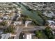 Wide aerial shot showcasing the neighborhood with lake views and mature greenery at 512 Shamrock Blvd, Venice, FL 34293