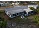 Aerial view of home showing backyard, enclosed porch, and outdoor lounging at 512 Shamrock Blvd, Venice, FL 34293
