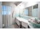 Bright bathroom with large mirror, vanity, and vintage tile at 512 Shamrock Blvd, Venice, FL 34293