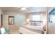 Spacious bedroom featuring a large bed, a ceiling fan, and windows providing plenty of natural light at 512 Shamrock Blvd, Venice, FL 34293