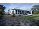 Back exterior of the property, featuring a screened-in sunroom at 512 Shamrock Blvd, Venice, FL 34293