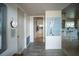 Bright hallway leading to the kitchen, featuring tiled floors and stylish decor at 512 Shamrock Blvd, Venice, FL 34293