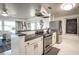Kitchen featuring stainless steel appliances, granite countertops, and access to the living room at 512 Shamrock Blvd, Venice, FL 34293