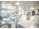 Bright living space with modern kitchen, glass top dining, and comfortable seating by large windows at 512 Shamrock Blvd, Venice, FL 34293