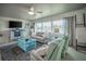 Bright living room with comfortable seating, fireplace, and large windows offering a view at 512 Shamrock Blvd, Venice, FL 34293