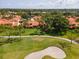 A serene villa community borders a golf course with mature trees and lush green landscaping at 5336 Huntingwood Ct # 24, Sarasota, FL 34235
