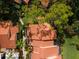 Close aerial view of neighborhood showing red tile roofs, landscaping and green space at 5336 Huntingwood Ct # 24, Sarasota, FL 34235