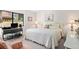 Bright bedroom with a white quilted bedspread, neutral walls, and decorative art pieces above the bed and desk at 5336 Huntingwood Ct # 24, Sarasota, FL 34235