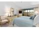 Bedroom with furniture, light carpet, and access to an outdoor patio at 5336 Huntingwood Ct # 24, Sarasota, FL 34235