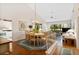 Dining and living room area boasts hardwood floors, chandelier, and large windows with lots of natural light at 5336 Huntingwood Ct # 24, Sarasota, FL 34235