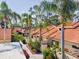 A row of charming villas with tile roofs, private courtyards, and lush landscaping creates a serene community at 5336 Huntingwood Ct # 24, Sarasota, FL 34235