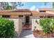 Charming villa with a private courtyard entrance, wrought iron gate, and lush landscaping at 5336 Huntingwood Ct # 24, Sarasota, FL 34235