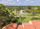 Rooftop view overlooking golf course, serene pond, sand trap, and lush greenery at 5336 Huntingwood Ct # 24, Sarasota, FL 34235